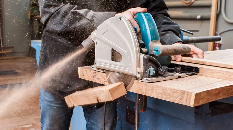 person using a circular saw