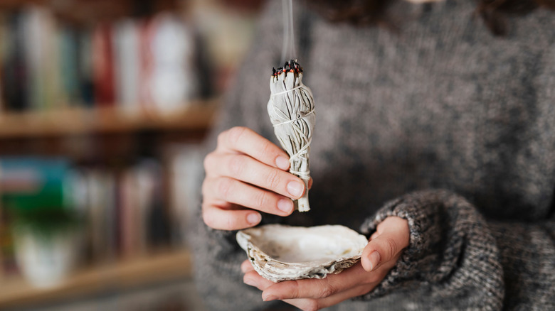 Person sage smudging