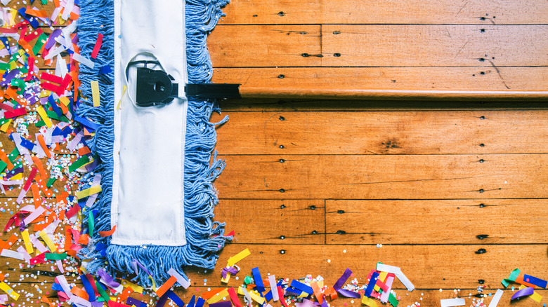 sweeping confetti with blue mop