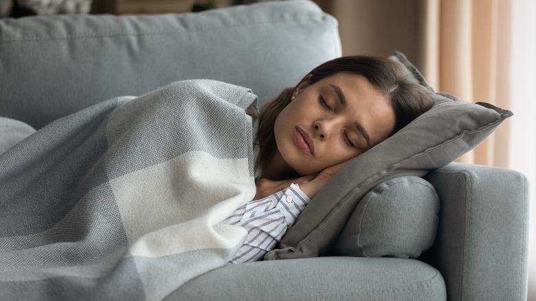 woman asleep on couch