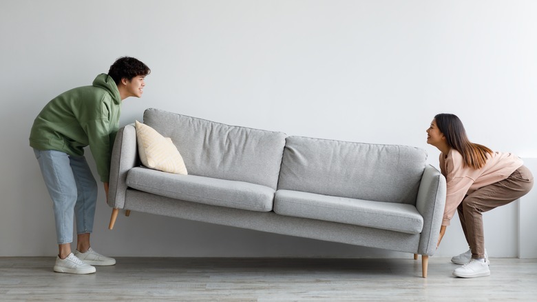 people moving gray couch