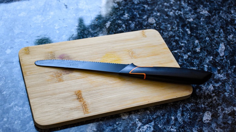 serrated knife on cutting board