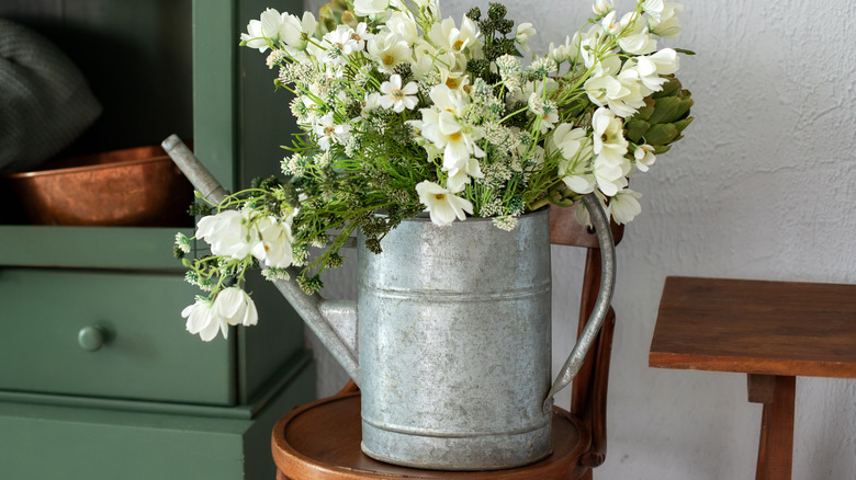 metal watering can with flowers