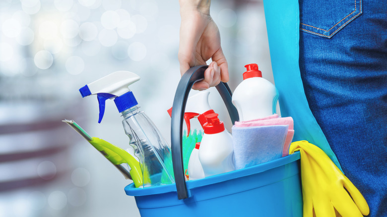 Person carrying cleaning supplies