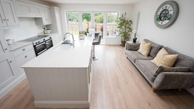 A large island in a living space with shiplap along the sides