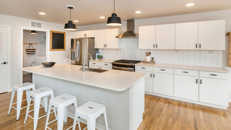 A modern white kitchen with shiplap backsplash