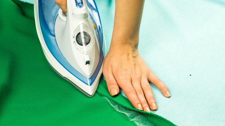 Person ironing curtains