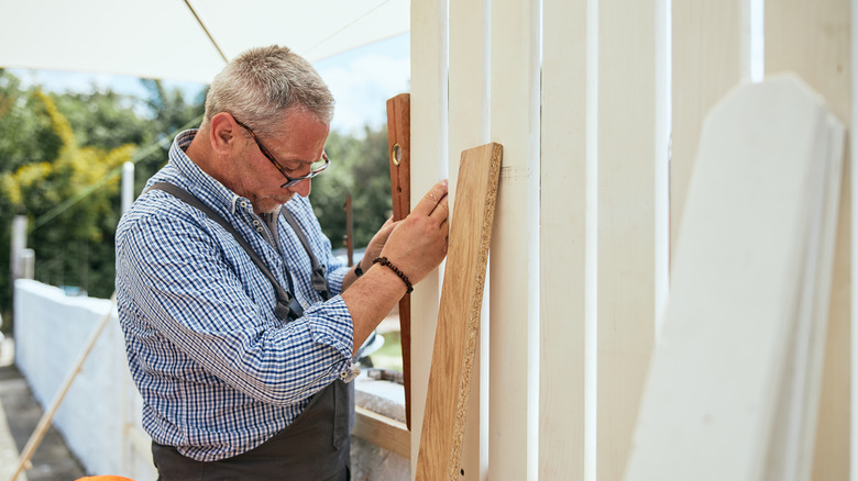 Man building fence in garden