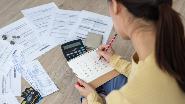 Woman marking billing due dates