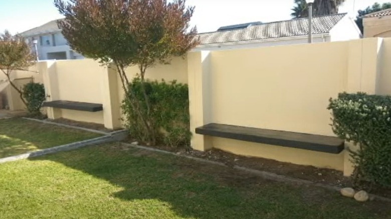 floating garden benches against wall fence