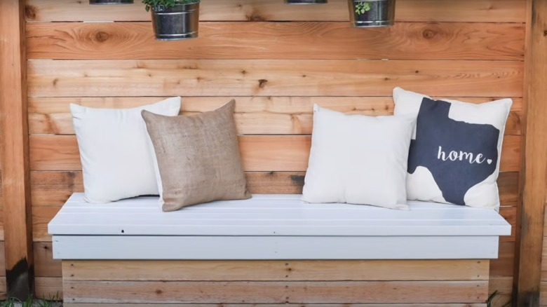 throw pillows on wooden garden bench