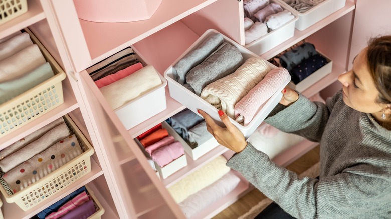 closet with drawers and clothes