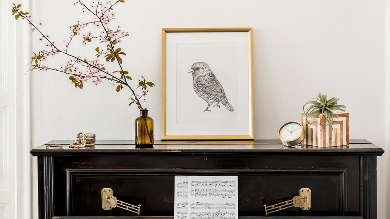 piano with framed picture and trinkets