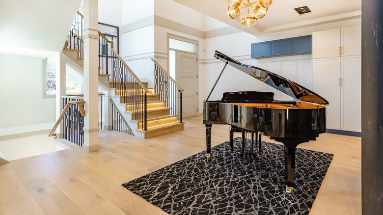 black grand piano on abstract rug