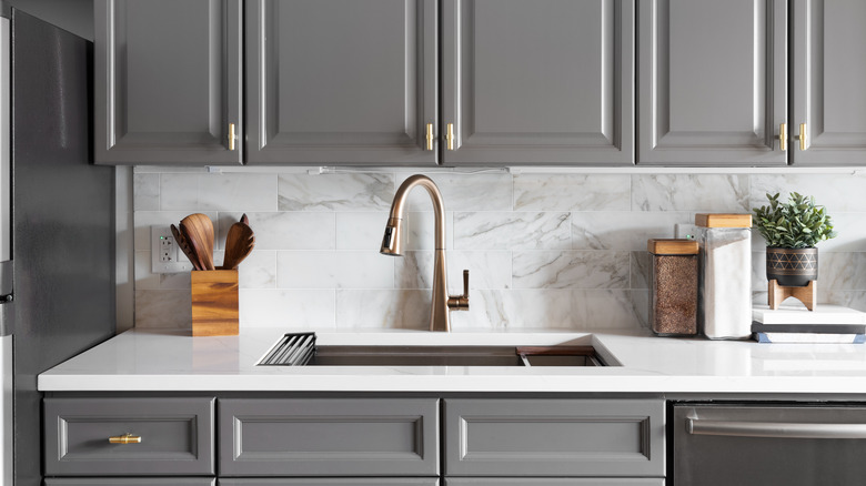 gray kitchen with brass hardware