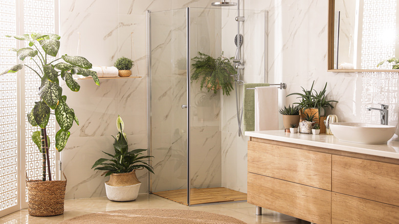 plants in white marble bathroom