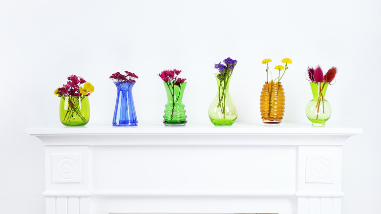 mantel with colorful glass vases