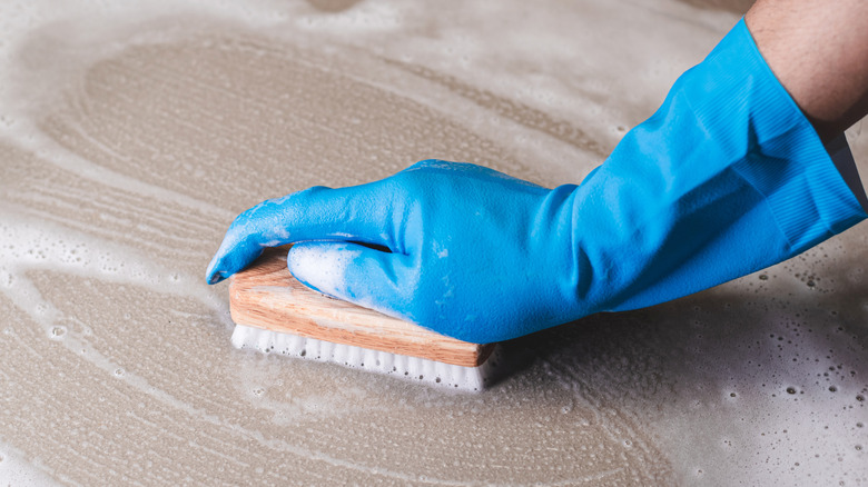 Man scrubbing floor tiles