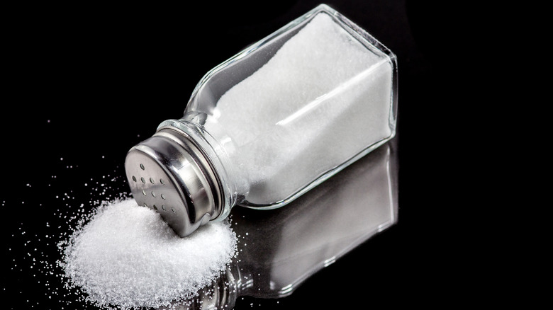salt shaker with spilled salt