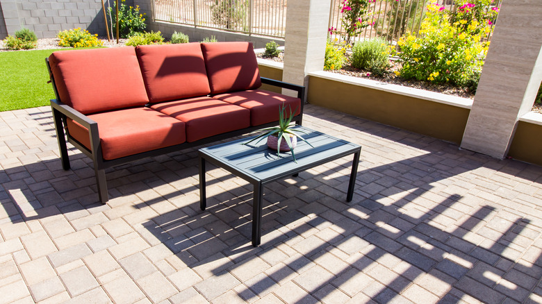 wrought iron couch with red cushions