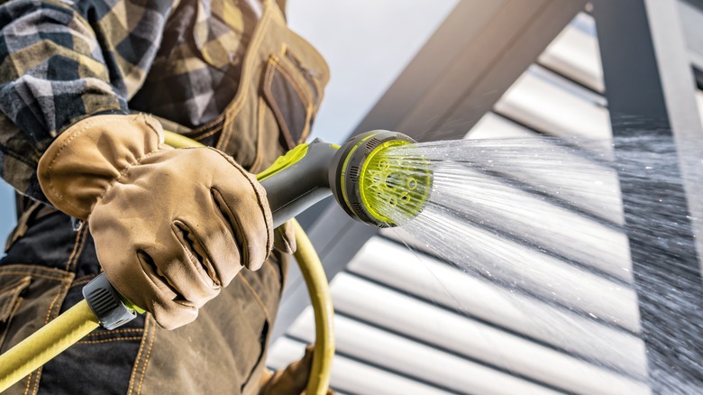 man using garden hose