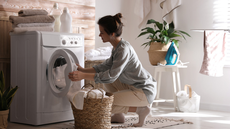 Woman grabbing items out of washer