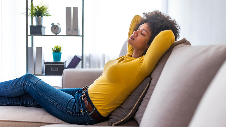 woman relaxing on recliner sofa