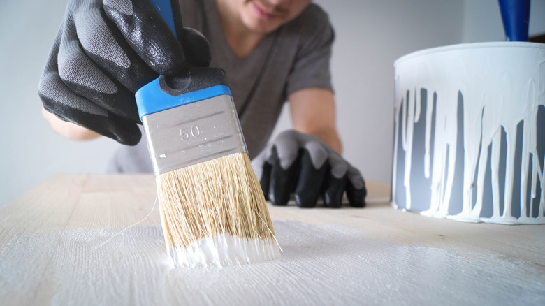 person painting a floor