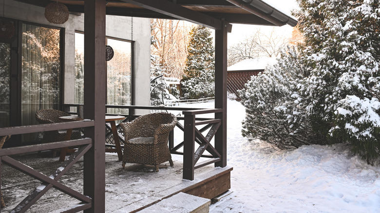 Snowy patio surrounded by trees