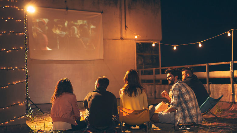 People watching movie on projector