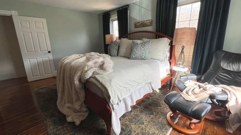 Bedroom with dark curtains and chair