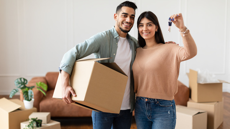 couple surrounded by moving boxes