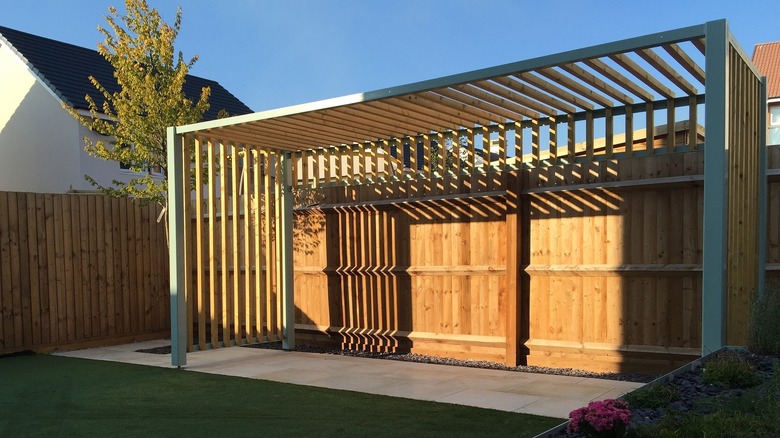 backyard concrete patio with pergola