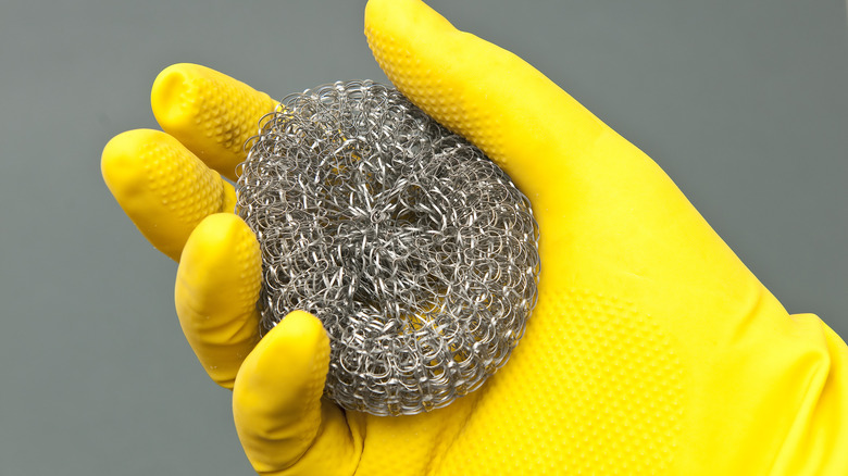 Person holding steel wool ball