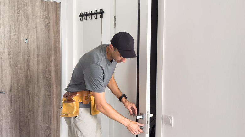 A man opens an interior door