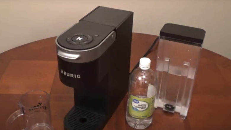 Keurig with bottle of vinegar