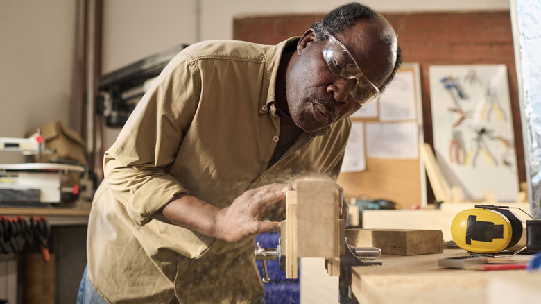 Carpenter cutting furniture pieces for built-in wardrobe