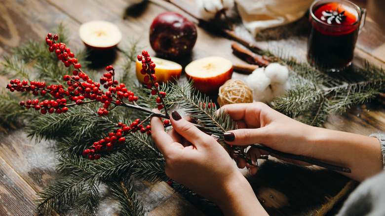 woman decorating wreath