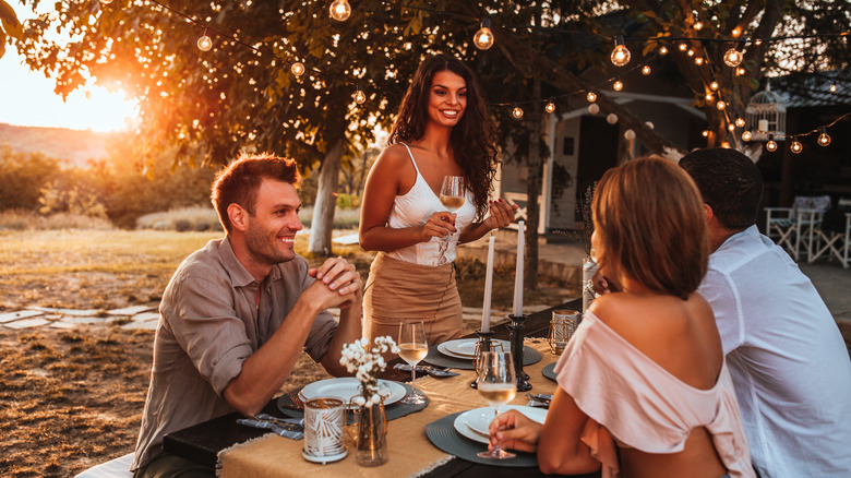 couples dinner outside at sunset