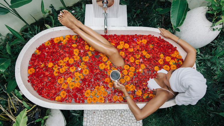 woman in bathtub with flowers