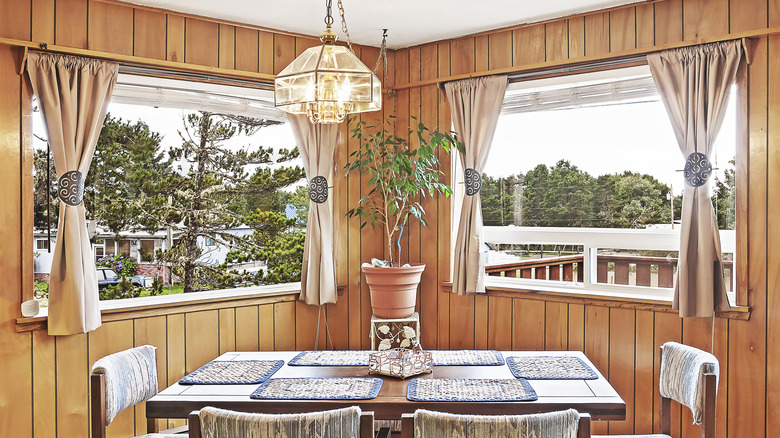 Dining room with wood paneled walls