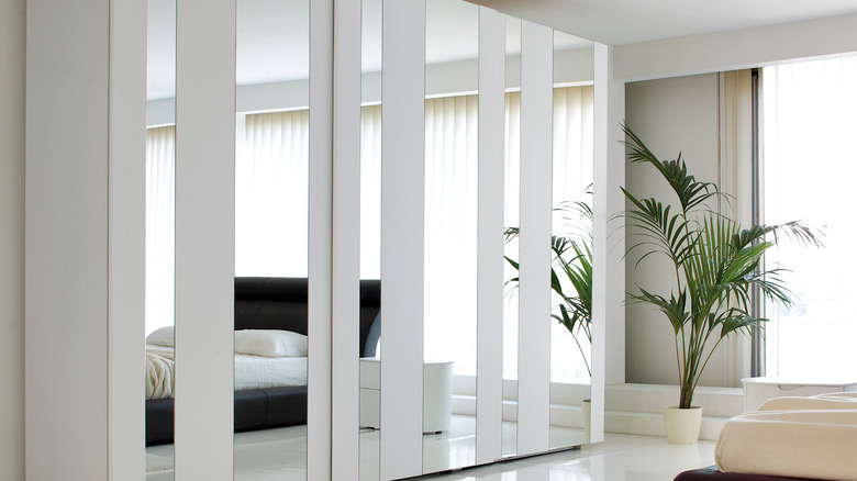 white mirrored wardrobe in bedroom