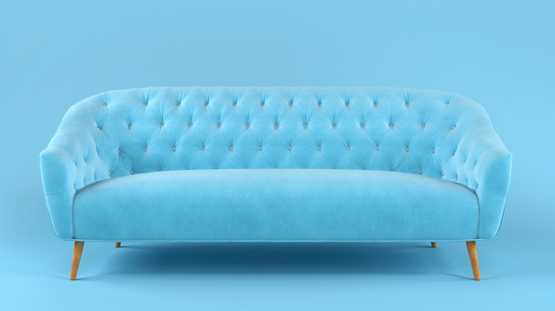 bright blue colored tufted couch