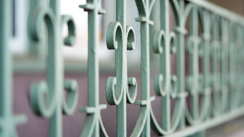 Art deco style fence topper on fence