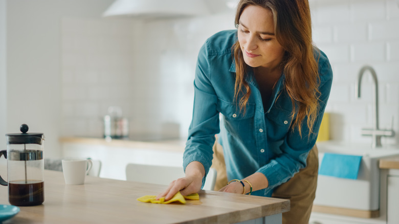 Woman wiping counter