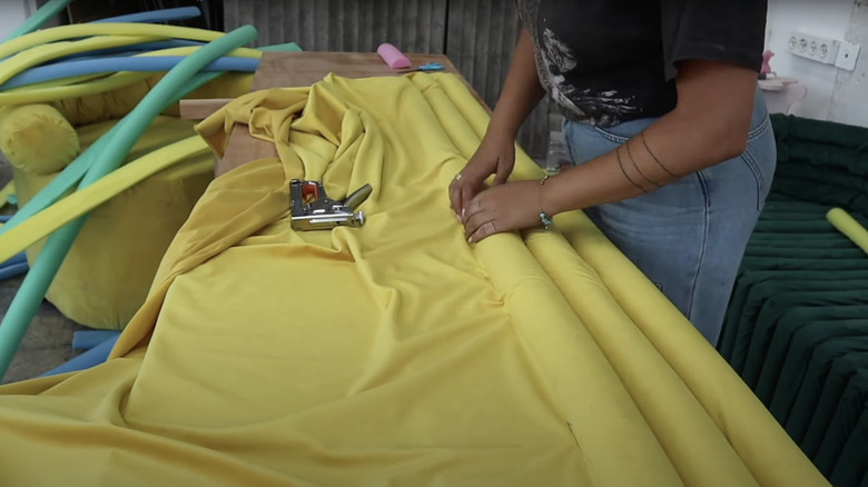 girl making pool noodle cushion 