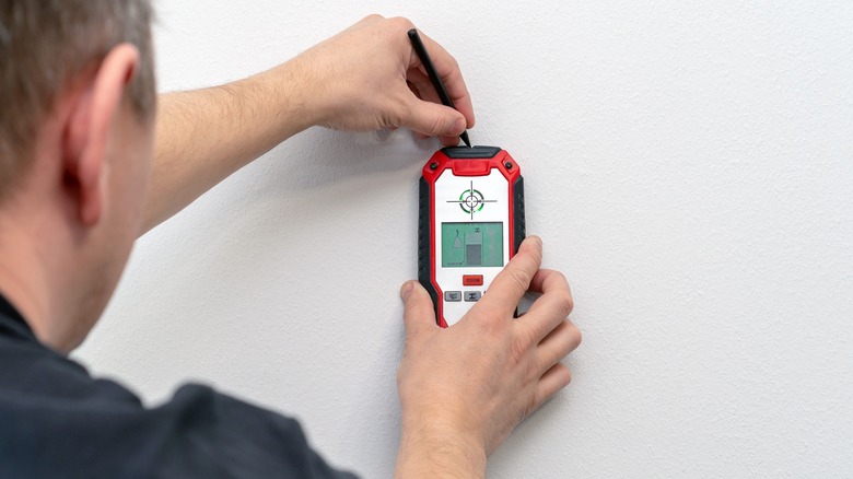 Person using stud finder