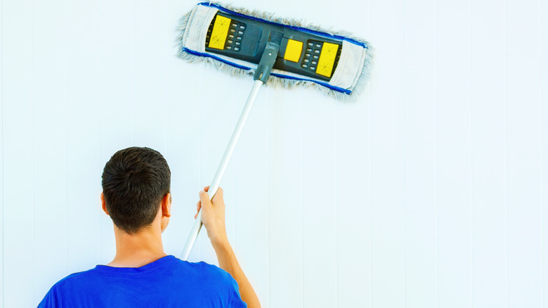 Cleaning walls with wet mop