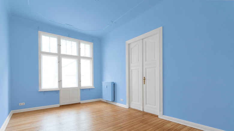 room with blue walls and window