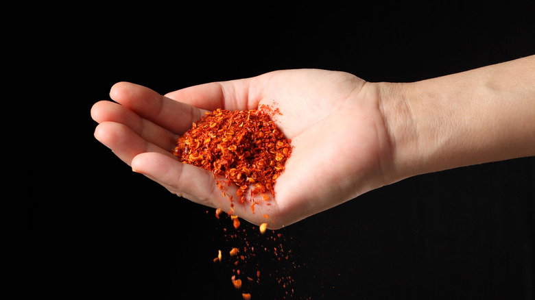 hand pouring cayenne pepper